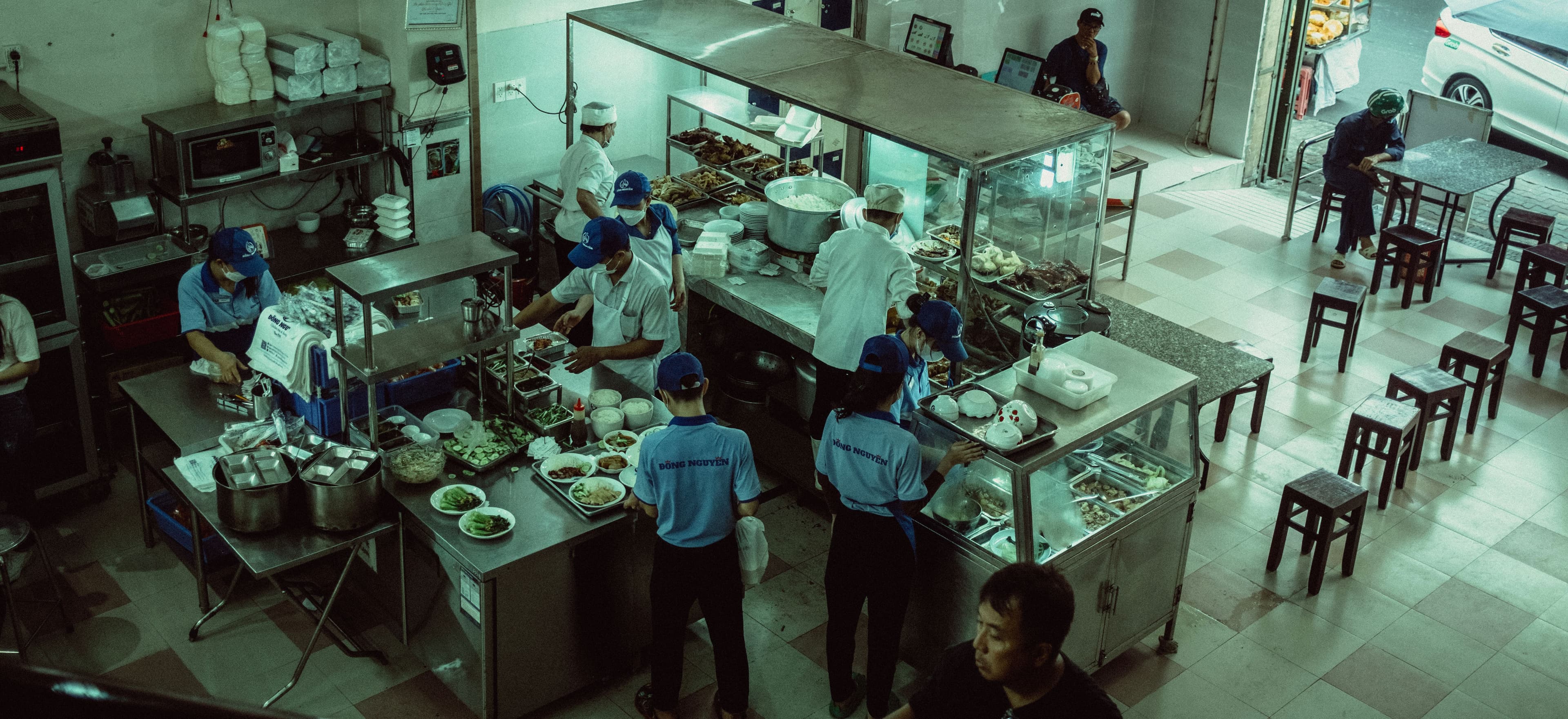 Restaurant prep line camera view with staff preparing food.